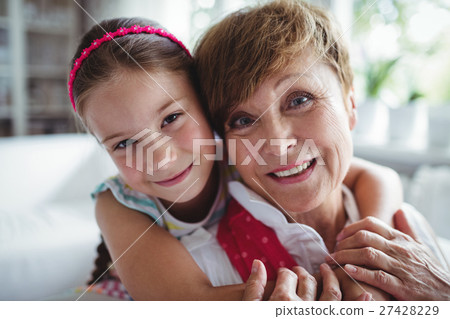Portrait of granddaughter embracing her grandmother 27428229