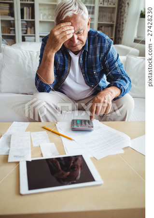 Tensed senior man checking the bills 27428230