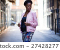 Portrait of young stylish black woman in dark city street woman 27428277