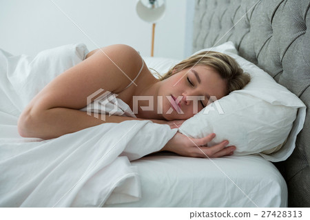 Young woman sleeping on her bed Young woman sleeping on her bed 27428313