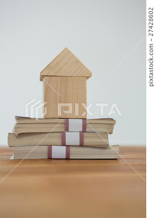 Model house on a pile of money Model house on a pile of money 27428602