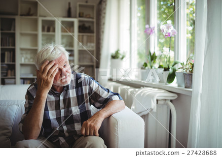 Tensed senior man sitting on sofa Tensed senior man sitting on sofa 27428688
