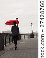 Young woman with umbrella walking by the river 27428766