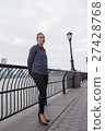 Young woman lost in thoughts by the river 27428768