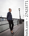 Young woman lost in thoughts by the river 27428771