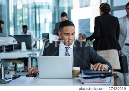 Businessman working on laptop 27429019