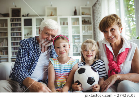 Portrait of grandparents sitting with their grandchildren 27429105