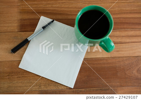 Close-up of coffee mug with blank paper and pen Close-up of coffee mug with blank paper and pen 27429107