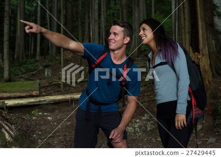 Hiker couple pointing at distance Hiker couple pointing at distance 27429445