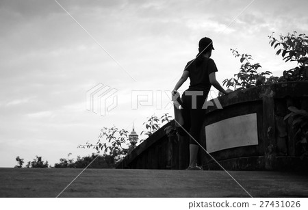 Unidentified woman jogger stretching on the bridge Unidentified woman jogger stretching on the bridge 27431026