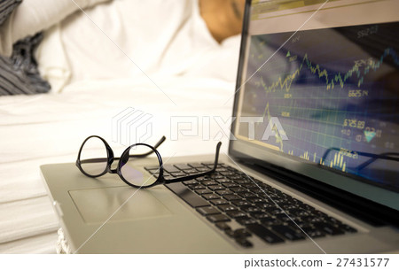 Businessman sleeping while working on laptop  27431577
