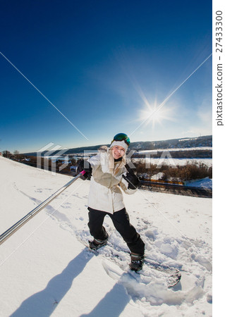 Young woman with the snowboard shooting a selfie Young woman with the snowboard shooting a selfie 27433300