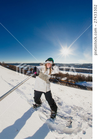 Young woman with the snowboard shooting a selfie Young woman with the snowboard shooting a selfie 27433302