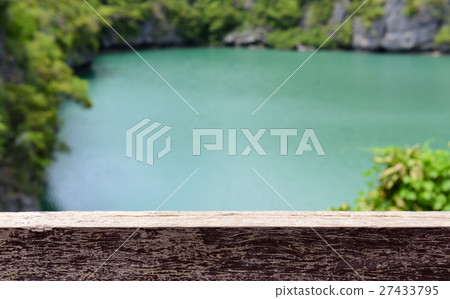 Wood plank over green lake and tree background. Wood plank over green lake and tree background. 27433795
