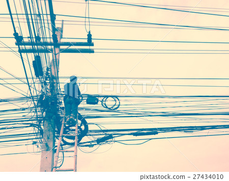 Electrician working on electric pole.  27434010