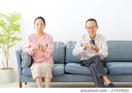 Senior looking at a smartphone Senior looking at a smartphone 27434693
