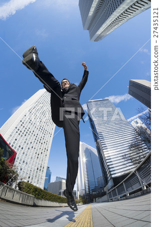 Jump and Guts pose Businessman looking up from directly below Aozora business city Shinjuku skyscraper district 27435121