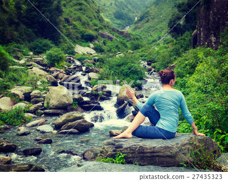 Woman doing Ardha matsyendrasana asana outdoors Woman doing Ardha matsyendrasana asana outdoors 27435323
