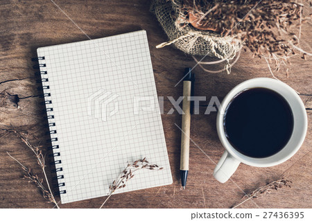 Notebook with cup of coffee on old wooden table 27436395