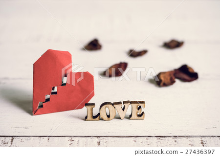 Red broken heart with dried rose petal 27436397