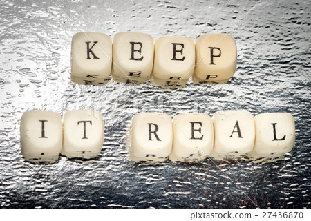 Keep it real text on a wooden cubes 27436870