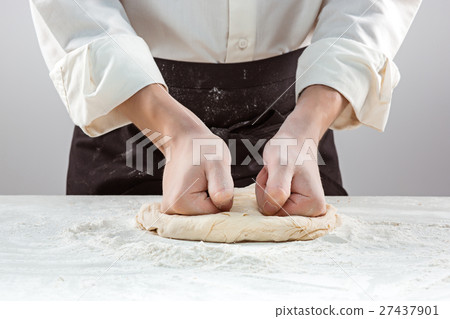 Hands kneading a dough Hands kneading a dough 27437901