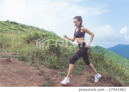 Cross-country female runner trail running on Cross-country female runner trail running on 27441962