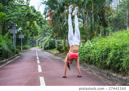 Front view of slim fit young woman practicing yoga Front view of slim fit young woman practicing yoga 27442168