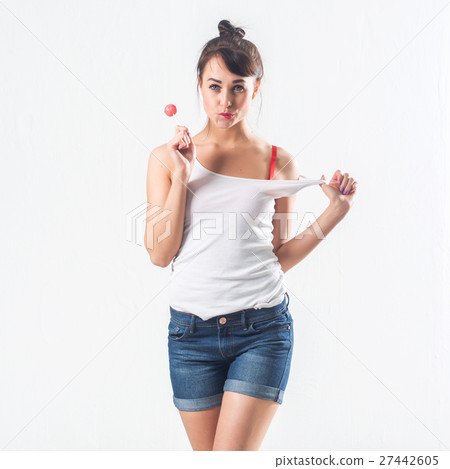 Young brunette model with lollipop posing studio Young brunette model with lollipop posing studio 27442605