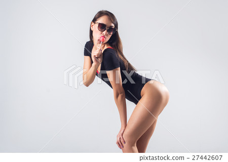Young brunette model with lollipop studio shot on Young brunette model with lollipop studio shot on 27442607