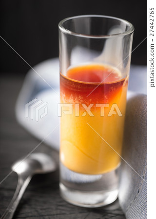 Cocktail of egg and cherry liqueur on background Cocktail of egg and cherry liqueur on background 27442765