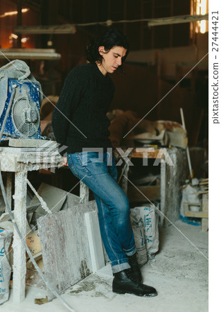 man in an old factory for the production of 27444421