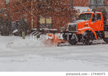 Snow clearing. Tractor clears the way after heavy snowfall. 27446975