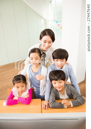 A Female Teacher And Her Young Students 27447640