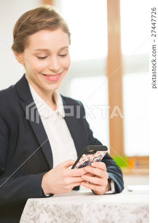 Foreign Female Teacher Looking At Her Phone 27447726