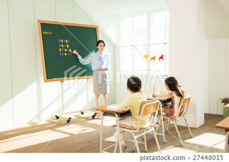 Young Students In Math Class With A Female Teacher Young Students In Math Class With A Female Teacher 27448015