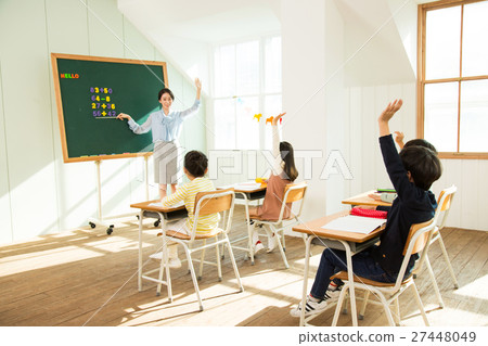 Young Students In Math Class With A Female Teacher Young Students In Math Class With A Female Teacher 27448049