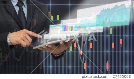 Businessman using the taplet shown the trading graph of stock market on the virtual screen over the stock chart background, Business stock market concept Businessman using the taplet shown the trading graph of stock market on the virtual screen over the stock chart background, Business stock market concept 27455068