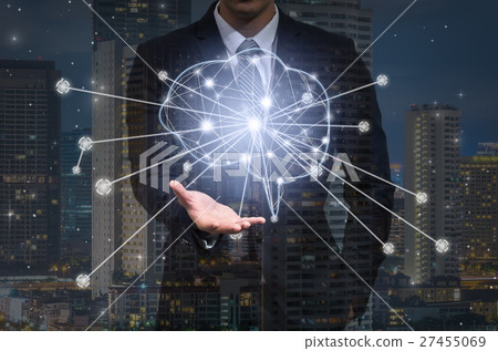Businessman hand holding the brain over the network connection and the building cityscape on dark background, technology and innovation concept Businessman hand holding the brain over the network connection and the building cityscape on dark background, technology and innovation concept 27455069
