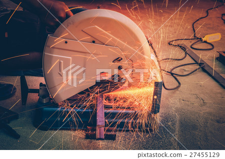 Closeup cutting process of metal material with sparks, industrial concept Closeup cutting process of metal material with sparks, industrial concept 27455129