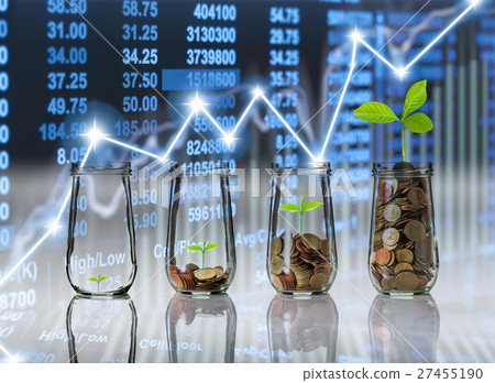 Gold coins and seed in clear bottle on Stock market exchange data on LED display background, Business investment growth and trading concept 27455190