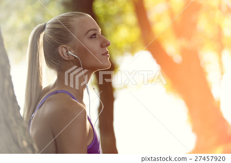 Breathing deep during jogging in the forest 27457920