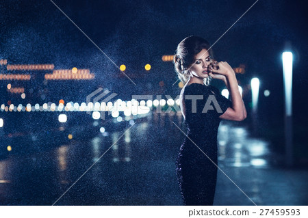 Woman posing in the rain. 27459593