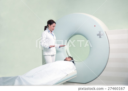 Mid adult nurse preparing patient for CT scan test 27460167