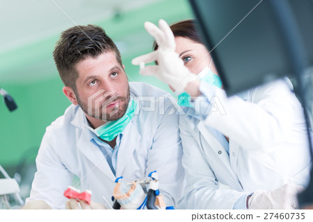Closeup of dentistry student practicing on a 27460735