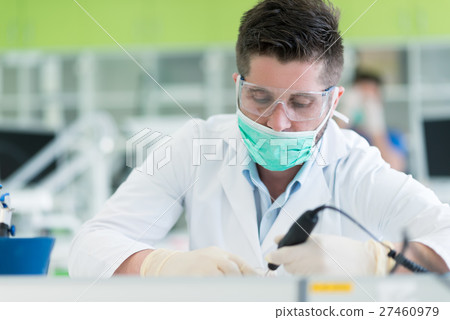 Closeup of dentistry student practicing on a Closeup of dentistry student practicing on a 27460979
