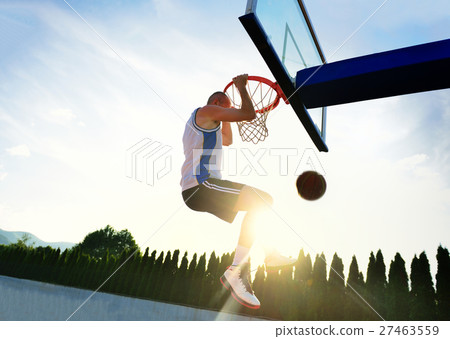 Young basketball player drives to the hoop for a 27463559