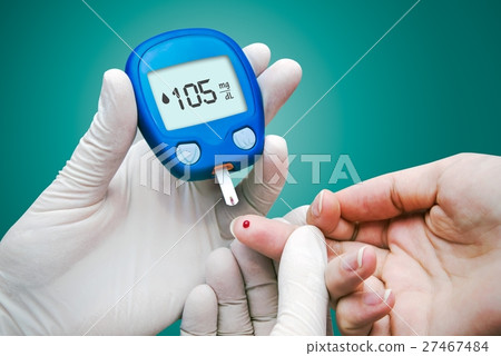 Doctor making blood sugar test.  27467484