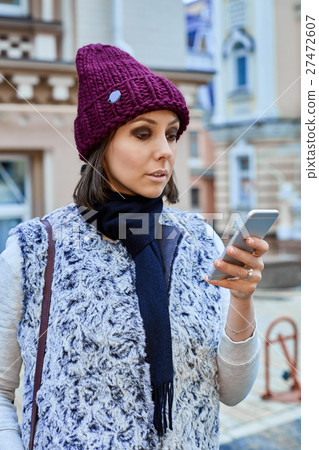 The girl with a smartphone in old town The girl with a smartphone in old town 27472607