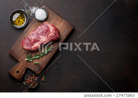 Raw ribeye beef steak cooking with ingredients Raw ribeye beef steak cooking with ingredients 27473863